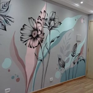 A beautifully designed floral mural on an interior wall, featuring black outline flowers with soft pastel shades of pink and blue, creating a modern and elegant aesthetic.