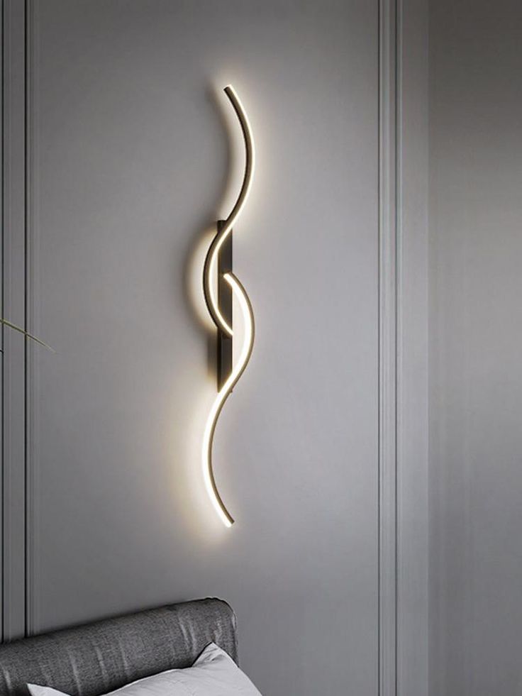 Modern wall lights illuminate a stylish bedroom, enhancing the contemporary decor and creating a warm ambiance.
