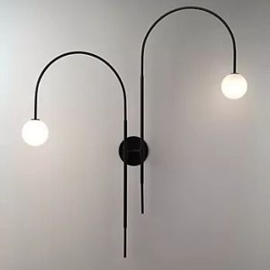 Dual arc wall light with hanging white globe bulbs.