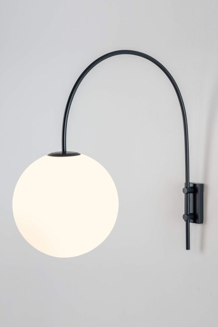 Contemporary Arched Wall Light Large round white globe wall light with a curved black stem.