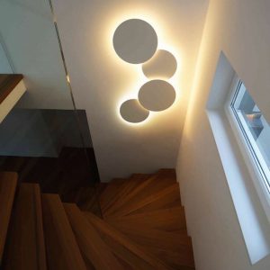 A staircase featuring circular lights overhead, enhancing the space with a modern and stylish design.